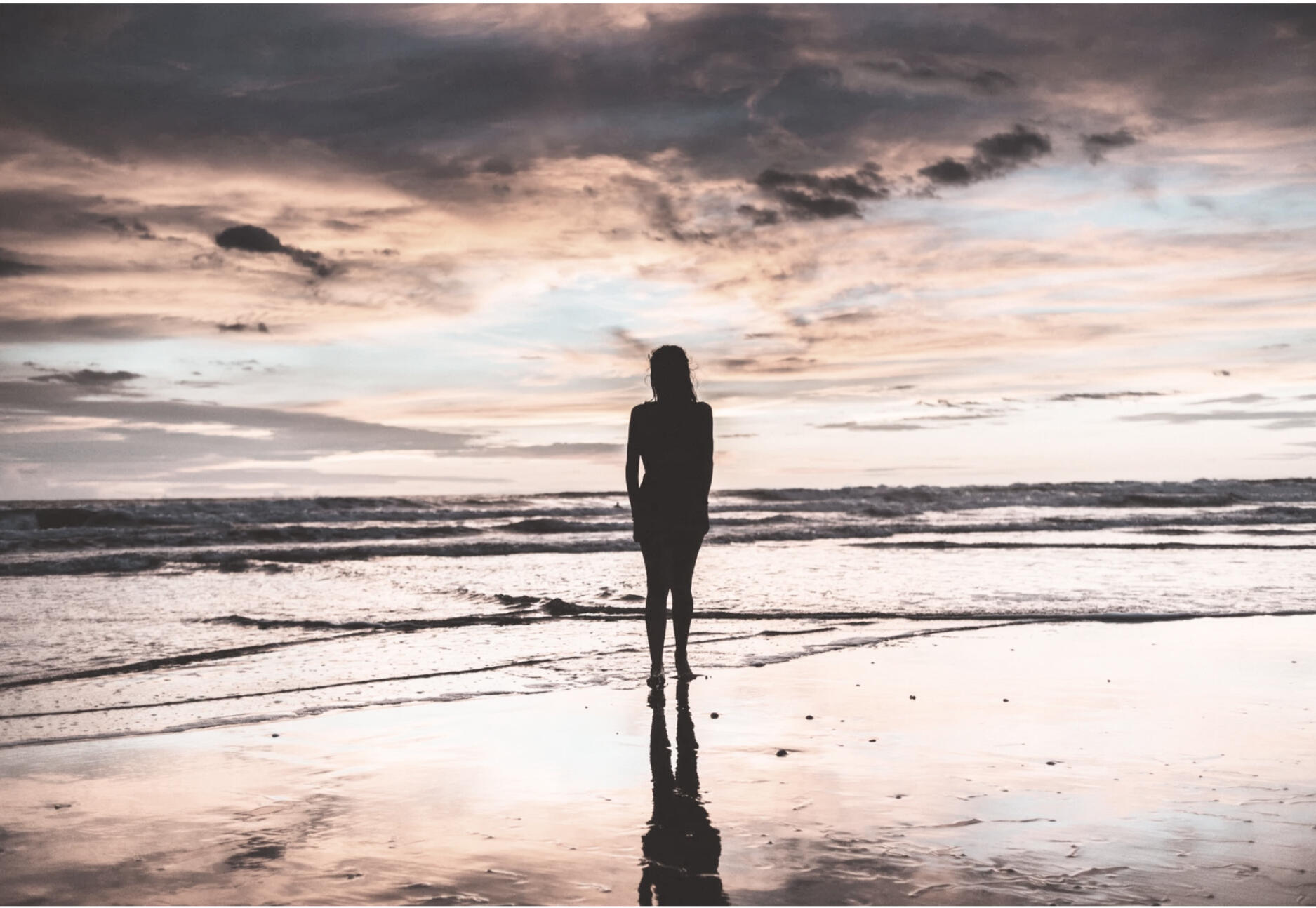 SoulPosture™ Somatic Healing and Nervous System Regulation Silhouette of a person at the ocean practicing somatic awareness and nervous system regulation through embodied posture reflection